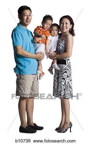 Stock Photo - Asian parents with young boy and baby daughter. Fotosearch