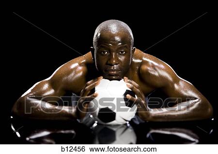Athlete posing with soccer ball View Large Photo Image Stock Photograph - Athlete posing with soccer ball. Fotosearch