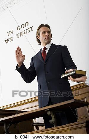 Stock Photography of Low angle view of a witness swearing over the ...