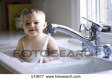 Baby bathing in sink View Large Photo Image Stock Photo - Baby bathing in sink. Fotosearch