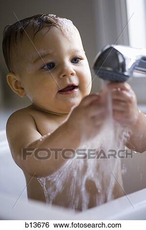 Stock Photograph - Baby bathing in sink. Fotosearch