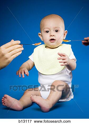 Baby being fed View Large Photo Image Stock Photo - Baby being fed. Fotosearch