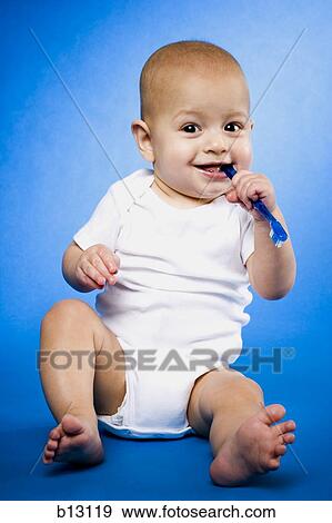 Baby chewing on toothbrush View Large Photo Image Stock Photo - Baby chewing on toothbrush. Fotosearch
