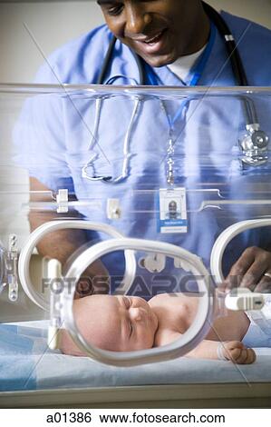 Baby in incubator with man in uniform View Large Photo Image Stock Photograph - Baby in incubator with man in uniform. Fotosearch