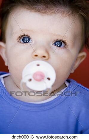 Baby with pacifier and blue eyes View Large Photo Image Stock Image - Baby with pacifier and blue eyes. Fotosearch