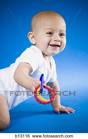 Stock Photograph - Baby with teething ring. Fotosearch
