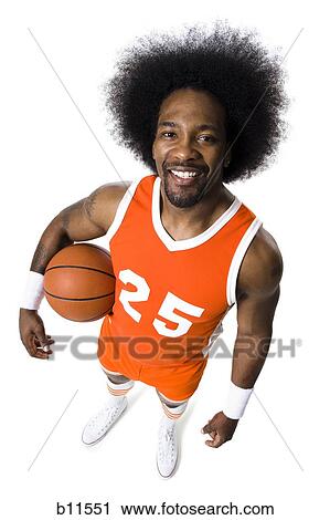 Stock Image - Basketball player with an afro in orange uniform. Fotosearch