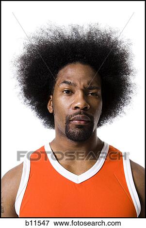 Basketball player with an afro in orange uniform View Large Photo Image Stock Photo - Basketball player with an afro in orange uniform. Fotosearch