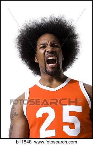 Basketball player with an afro in orange uniform View Large Photo Image Stock Photo - Basketball player with an afro in orange uniform. Fotosearch