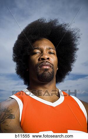 Stock Photography - Basketball player with an afro in orange uniform. Fotosearch
