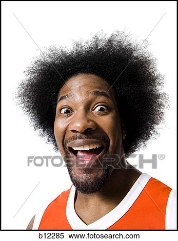 Stock Photography - Basketball player with an afro in orange uniform. Fotosearch
