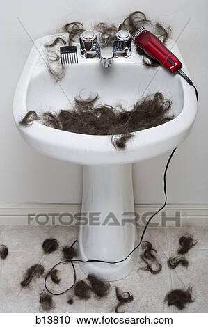 Stock Image - Bathroom sink with hair and electric razor. Fotosearch