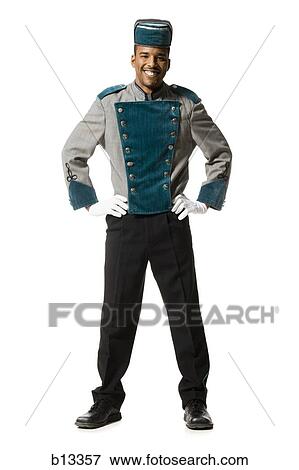 Stock Photo - Bellboy smiling full length. Fotosearch