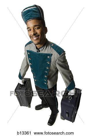 Bellboy with luggage smiling View Large Photo Image Stock Image - Bellboy with luggage smiling. Fotosearch