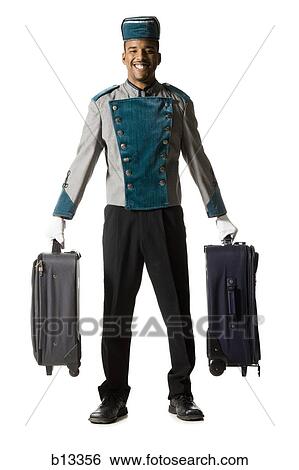 Bellboy with luggage smiling View Large Photo Image Stock Photograph - Bellboy with luggage smiling. Fotosearch