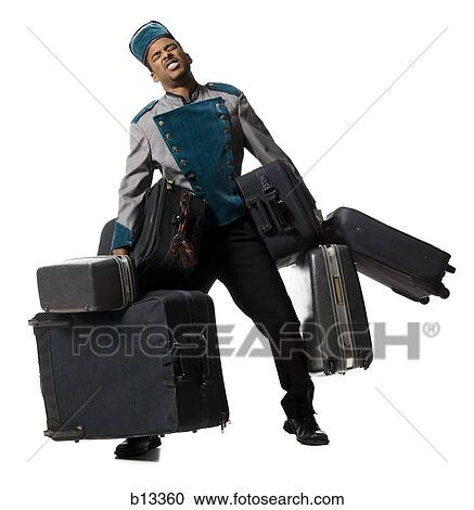 Bellboy with luggage struggling View Large Photo Image Stock Image - Bellboy with luggage struggling. Fotosearch