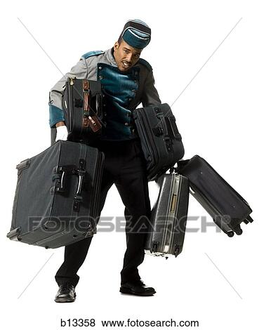 Bellboy with luggage struggling View Large Photo Image Stock Photo - Bellboy with luggage struggling. Fotosearch