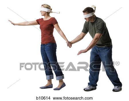 Blindfolded young woman leading to a blindfolded young man View Large Photo Image Picture - Blindfolded young woman leading to a blindfolded young man. Fotosearch