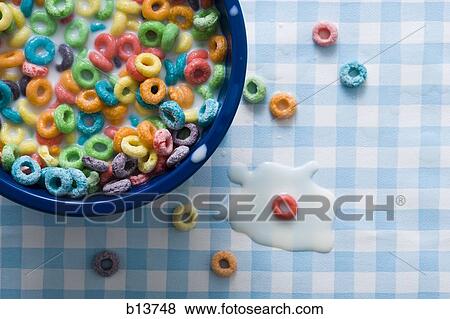 Stock Photo - Bowl of cereal detailed view with spilled milk on tablecloth. Fotosearch