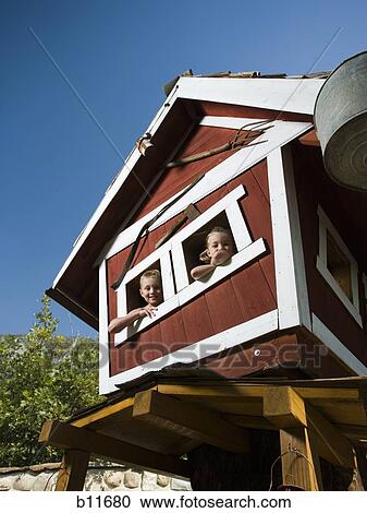 Boy and girl in a playhouse View Large Photo Image Stock Image - Boy and girl in a playhouse. Fotosearch