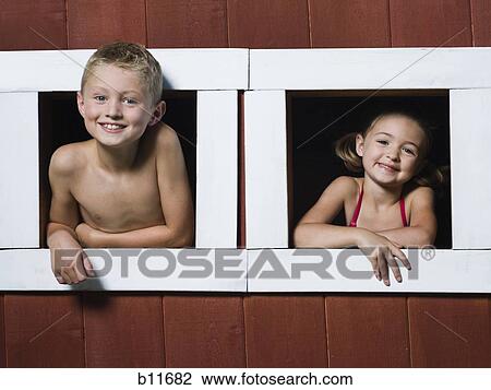 Stock Image - Boy and girl in a playhouse. Fotosearch