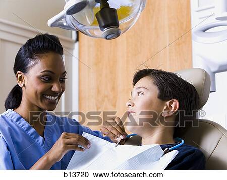 Boy at dentist with hygienist View Large Photo Image Stock Image - Boy at dentist with hygienist. Fotosearch