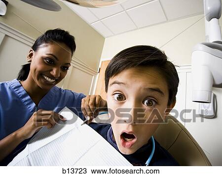 Boy at dentist with hygienist View Large Photo Image Stock Image - Boy at dentist with hygienist. Fotosearch