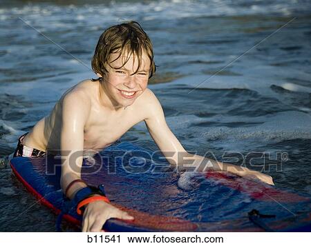 Boy boogie boarding View Large Photo Image Stock Image - Boy boogie boarding. Fotosearch
