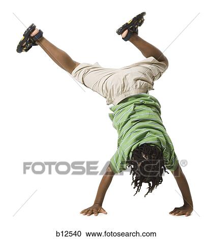 Stock Image - Boy doing a cartwheel. Fotosearch