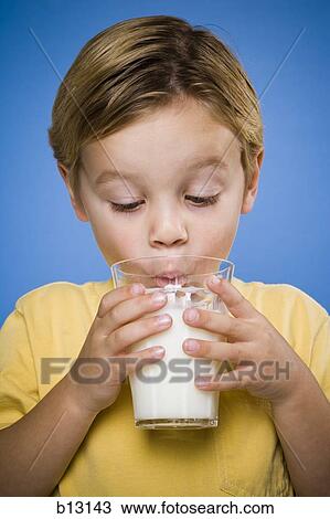 Stock Image - Boy drinking glass of milk. Fotosearch