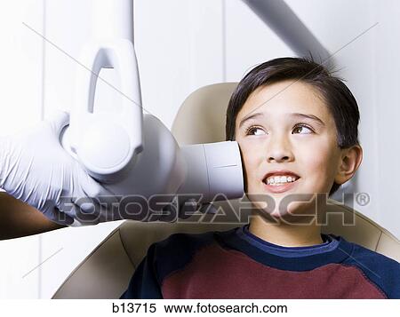 Stock Photography - Boy having dental x-rays. Fotosearch