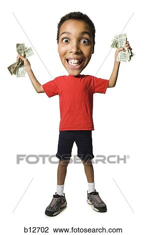 Stock Image - Boy holding fistfuls of US dollar bills. Fotosearch