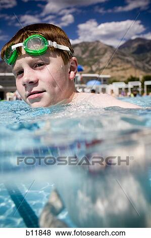 Stock Photo - Boy in a swimming pool. Fotosearch