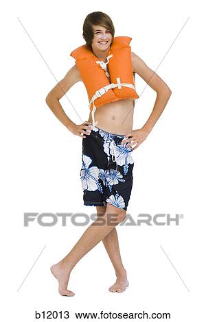 Boy in swim trunks with life vest View Large Photo Image Stock Image - Boy in swim trunks with life vest. Fotosearch