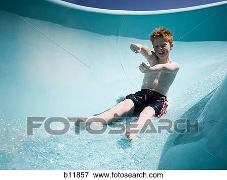 Stock Photo - Boy on a waterslide. Fotosearch