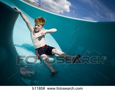 Stock Photo - Boy on a waterslide. Fotosearch