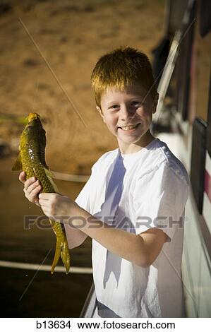 Boy on boat outdoors with fish View Large Photo Image Picture - Boy on boat outdoors with fish. Fotosearch