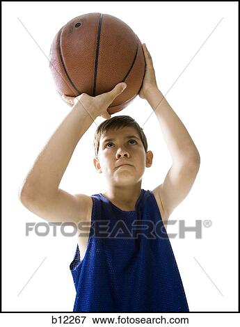 Boy playing basketball and taking a shot View Large Photo Image Stock Photo - Boy playing basketball and taking a shot. Fotosearch