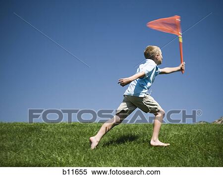 Boy playing on a hill View Large Photo Image Stock Photography - Boy playing on a hill. Fotosearch