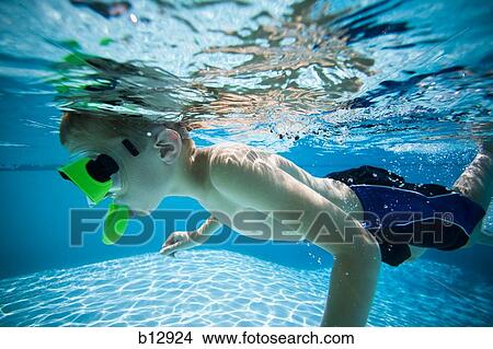 Boy swimming underwater in pool View Large Photo Image Picture - Boy swimming underwater in pool. Fotosearch