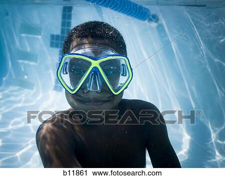 Boy swimming underwater in pool View Large Photo Image Stock Image - Boy swimming underwater in pool. Fotosearch