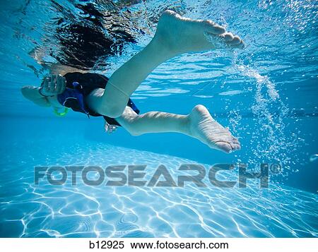 Stock Photography - Boy swimming underwater in pool. Fotosearch