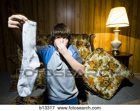 Stock Photo - Boy with dirty sock. Fotosearch