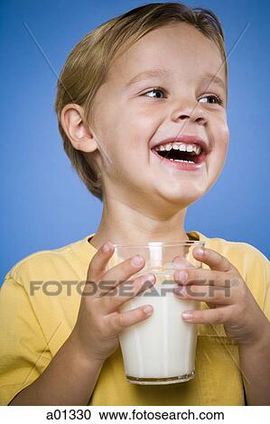 Boy with glass of milk laughing View Large Photo Image Stock Image - Boy with glass of milk laughing. Fotosearch