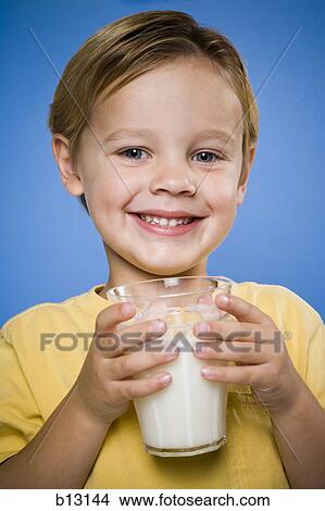 Boy with glass of milk smiling View Large Photo Image Picture - Boy with glass of milk smiling. Fotosearch