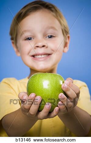 Boy with green apple smiling View Large Photo Image Stock Photograph - Boy with green apple smiling. Fotosearch