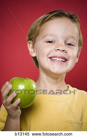 Boy with green apple smiling View Large Photo Image Stock Photography - Boy with green apple smiling. Fotosearch