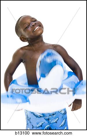 Stock Image - Boy with swim trunks and inflatable toy. Fotosearch