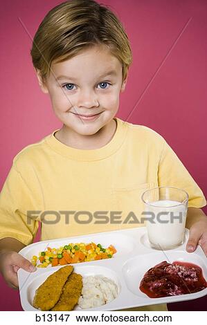 Stock Photo - Boy with tray of food. Fotosearch