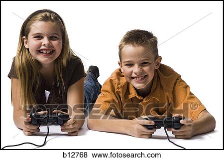 Brother and sister playing a video game View Large Photo Image Stock Photo - Brother and sister playing a video game. Fotosearch